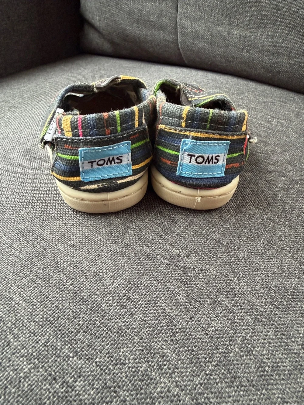 TOMS Baby Slip-On Shoes in Black with Multicolor Stripes